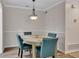 Charming dining room with modern chandelier and hardwood floors at 110 Barrington Hills Dr # 110, Atlanta, GA 30350