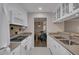 Functional kitchen with white appliances, ample countertop space, and an open view to the dining room at 110 Barrington Hills Dr # 110, Atlanta, GA 30350