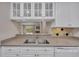 Bright kitchen with white cabinets, stainless steel sink, and a pass-through to the living area at 110 Barrington Hills Dr # 110, Atlanta, GA 30350