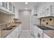 Galley kitchen featuring white cabinets, neutral countertops, and essential appliances at 110 Barrington Hills Dr # 110, Atlanta, GA 30350