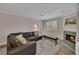 Cozy living room with fireplace, laminate floors and abundant natural light at 110 Barrington Hills Dr # 110, Atlanta, GA 30350
