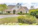 Community clubhouse featuring stone and siding, a well-manicured lawn, and lovely landscaping at 1304 Slate Bend Dr, Dacula, GA 30019