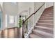 Inviting home foyer with hardwood floors, staircase, and a clear view of the dining room at 1304 Slate Bend Dr, Dacula, GA 30019