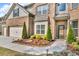 Well maintained entrance to this home with manicured landscaping and three car garage at 1304 Slate Bend Dr, Dacula, GA 30019