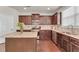 Modern kitchen with stainless steel appliances, dark wood cabinets, and granite countertops at 1304 Slate Bend Dr, Dacula, GA 30019