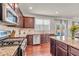 Spacious kitchen featuring granite counters, stainless appliances and island with hardwood floors at 1304 Slate Bend Dr, Dacula, GA 30019