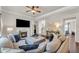 Cozy living room featuring a fireplace, large sectional sofa, and hardwood floors at 1304 Slate Bend Dr, Dacula, GA 30019