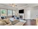 Well-lit living room featuring a fireplace and hardwood floors with views of the yard at 1304 Slate Bend Dr, Dacula, GA 30019