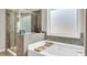 The main bath has a tiled shower with built-in shower seat and plenty of natural light at 1304 Slate Bend Dr, Dacula, GA 30019