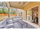 The covered patio features a ceiling fan, seating, and a large rug with an indoor/outdoor connection at 1304 Slate Bend Dr, Dacula, GA 30019