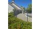 Community pool area behind a black metal fence with green bushes in the foreground at 1304 Slate Bend Dr, Dacula, GA 30019