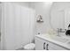 Bathroom with a clean white shower curtain and matching vanity with a decorative mirror at 200 Chestnut Cir, Atlanta, GA 30342