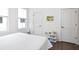 Bright bedroom featuring three windows and a shelf with a small storage bin at 200 Chestnut Cir, Atlanta, GA 30342