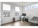 Bright office space with three windows, a desk, and a comfortable gray chair at 200 Chestnut Cir, Atlanta, GA 30342