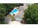 Aerial view of the property featuring a pool, mature trees, and surrounding greenery at 3818 Bay Forest Way, Loganville, GA 30052