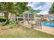 Lush backyard featuring a pool, a screened-in porch, mature trees, and a well-manicured lawn at 3818 Bay Forest Way, Loganville, GA 30052