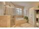 Bathroom with a glass enclosed shower, a soaking tub, and neutral-toned tile at 3818 Bay Forest Way, Loganville, GA 30052