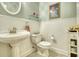Bathroom features pedestal sink, toilet, and wainscoting walls at 3818 Bay Forest Way, Loganville, GA 30052