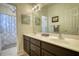 Bathroom with double vanity sinks, a large mirror, and tiled floors providing ample space and functionality at 3818 Bay Forest Way, Loganville, GA 30052
