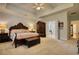 Expansive bedroom with tray ceilings, wood furniture and ensuite bathroom offering a private retreat at 3818 Bay Forest Way, Loganville, GA 30052