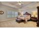 Large bedroom with tray ceilings, wood furniture and plantation shutters offering a luxurious retreat at 3818 Bay Forest Way, Loganville, GA 30052