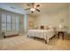 Serene bedroom featuring neutral tones, plantation shutters, and a cozy seating area for relaxation and comfort at 3818 Bay Forest Way, Loganville, GA 30052