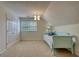 Attic bedroom featuring an accent daybed, neutral carpet, and bright natural light at 3818 Bay Forest Way, Loganville, GA 30052