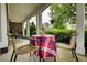Cozy covered porch with table, chairs, and classic columns, perfect for outdoor relaxation at 3818 Bay Forest Way, Loganville, GA 30052