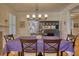 Dining room with hardwood floors, chandelier, and fireplace, creating an elegant atmosphere at 3818 Bay Forest Way, Loganville, GA 30052