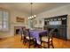 Formal dining room with large windows, hardwood floors, and elegant black china cabinet at 3818 Bay Forest Way, Loganville, GA 30052