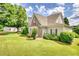 Landscaped front yard and stylish exterior featuring stone and siding at 3818 Bay Forest Way, Loganville, GA 30052