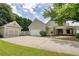 Spacious home featuring a detached garage, long driveway, and well-maintained lawn at 3818 Bay Forest Way, Loganville, GA 30052