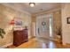 Welcoming foyer with a decorative front door, hardwood floors, and stylish console table at 3818 Bay Forest Way, Loganville, GA 30052