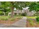 Charming home with lush greenery, inviting walkway, and stone accents at 3818 Bay Forest Way, Loganville, GA 30052