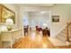 Open hallway leading to living room and dining areas, with hardwood floors at 3818 Bay Forest Way, Loganville, GA 30052