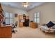 Bright office space with built-in desk, carpet, and natural light from windows at 3818 Bay Forest Way, Loganville, GA 30052