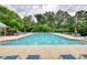 A large rectangular community pool is surrounded by lounge chairs and lush greenery, offering a relaxing oasis at 3818 Bay Forest Way, Loganville, GA 30052