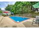 Pool area offers a tranquil retreat surrounded by trees and a privacy fence with patio furniture for relaxation at 3818 Bay Forest Way, Loganville, GA 30052