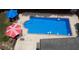 Refreshing swimming pool with lounge chairs and umbrellas, ideal for summer fun at 3818 Bay Forest Way, Loganville, GA 30052