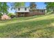 A sloped backyard featuring a brick house with a covered patio, perfect for outdoor enjoyment and entertaining at 46 Hawkins Store Nw Rd, Kennesaw, GA 30144