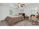 Bedroom with traditional furnishings, including wood desk and nightstand, and brightened by two natural light filled windows at 46 Hawkins Store Nw Rd, Kennesaw, GA 30144