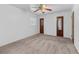 Carpeted bedroom featuring a ceiling fan and multiple doors at 46 Hawkins Store Nw Rd, Kennesaw, GA 30144