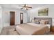 Staged bedroom featuring neutral colors, closet, ceiling fan and bathroom access at 46 Hawkins Store Nw Rd, Kennesaw, GA 30144