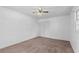 Empty carpeted bedroom featuring a ceiling fan and closet at 46 Hawkins Store Nw Rd, Kennesaw, GA 30144