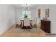 Dining room with hardwood floors, a chandelier, and seating for six around a dark wood table at 46 Hawkins Store Nw Rd, Kennesaw, GA 30144