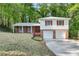 Split-level home showcasing brick and white siding, complemented by an expansive driveway and lush surroundings at 46 Hawkins Store Nw Rd, Kennesaw, GA 30144