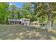 Charming two-story home with a well-manicured lawn and mature trees, creating a serene and inviting atmosphere at 46 Hawkins Store Nw Rd, Kennesaw, GA 30144