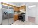 Well-lit kitchen with stainless steel refrigerator, tile backsplash, and view into adjacent room at 46 Hawkins Store Nw Rd, Kennesaw, GA 30144