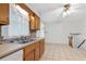 Bright eat-in kitchen boasts tile floors, double basin sink, and stairway access at 46 Hawkins Store Nw Rd, Kennesaw, GA 30144