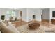 Open-concept living room and dining area featuring beautiful hardwood floors and modern decor at 46 Hawkins Store Nw Rd, Kennesaw, GA 30144